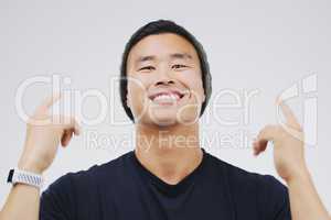 Hes always been the coolest guy around. Studio shot of a handsome young man looking cheerful and dancing against a grey background.