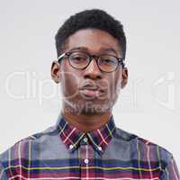 He keeps his feelings to himself. Studio portrait of a handsome young man posing expressionless against a grey background.