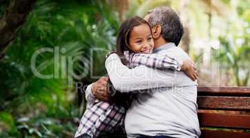 Granddaddys little princess. an adorable little girl hugging her grandfather in the park.