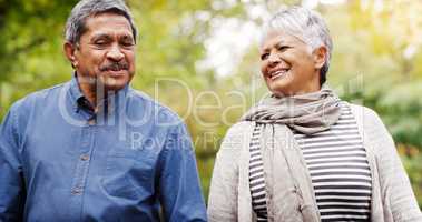 Taking some time to tell stories of our golden days. a cheerful senior couple relaxing together at the park.