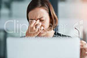 I need to take some time off. a young businesswoman looking stressed while working in an office.