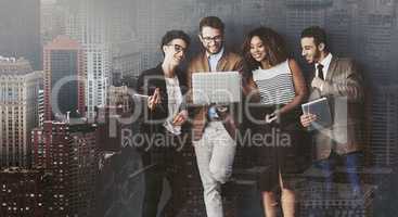 Sharing is easier when youre connected. Studio shot of a group of businesspeople using wireless technology while standing in line against a gray background.