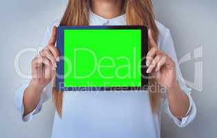 Enter your caption right here. an unrecognizable woman holding a digital tablet against a blue background.