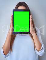 Anonymous profile online. an unrecognizable woman holding a digital tablet against a blue background.