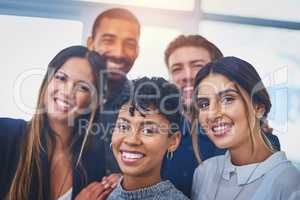 Our dynamic partnership gives us an edge in the industry. Portrait of a cheerful group of young businesspeople smiling and posing together at work.