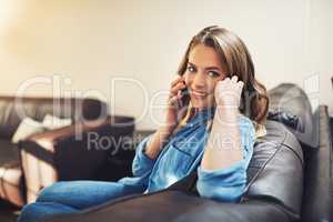 I really appreciate you taking the time to call. a relaxed young woman using a smartphone on the sofa at home.