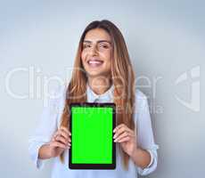 Im guilty of being myself at all times. Portrait of an attractive young woman holding a digital tablet against a blue background.