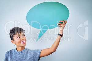 Anyone care to offer me some good advice. Portrait of an attractive young woman holding up a speech bubble against a blue background.