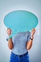She has a big say behind the scenes. an unrecognizable woman holding up a speech bubble against a blue background.