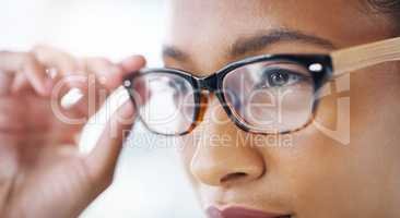 She sees success is on the way. Closeup shot of an attractive young businesswoman wearing spectacles in a modern office.