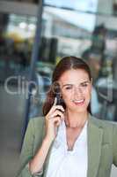 Wonderful, lets arrange that. a young businesswoman using a mobile phone in a modern office.