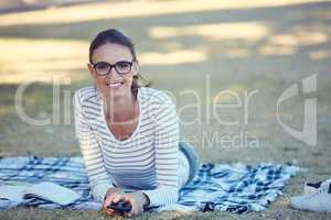 Days off done just right. Portrait of an attractive young woman relaxing in the park.