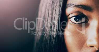 One look at her can change your whole world. Closeup shot of a beautiful young womans eye against a dark background.