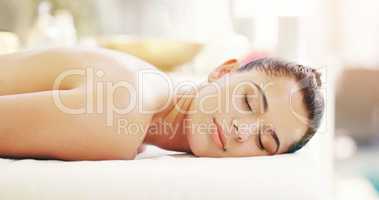 Today day is reserved for yourself. a young woman relaxing on a massage bed at a spa.