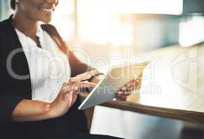 Scoping the digital sphere for new opportunities. Closeup shot of a businesswoman using a digital tablet in an office.