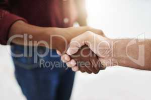 Closeup handshake showing success, support and trust between collaborating businessmen. Fingers of creative office business colleagues making a deal and agreeing or welcoming, greeting and promoting