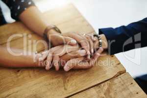Hands holding abuse victim in a therapy session for support and comfort by a professional psychologist on a wooden table. Kind and caring therapist touching to show care and affection in counseling