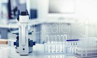 Closeup of microscope, test tubes and pipettes or droppers in medical, science or chemistry laboratory. Empty glass vials for monkeypox, ebola or marburg virus testing, examining and discovering cure