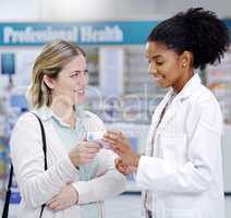 Great service always leaves everyone happier. a young pharmacist recommending a health care product to a young woman at a pharmacy.