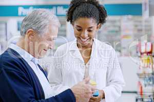 Helping you find better health solutions. a young pharmacist recommending a health care product to a senior citizen at a pharmacy.