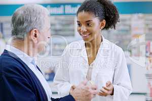 Great service involves finding out what customers need and value. a young pharmacist recommending a health care product to a senior citizen at a pharmacy.