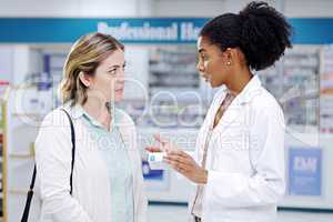 We prioritise helping you make better health choices. a young pharmacist recommending a health care product to a young woman at a pharmacy.