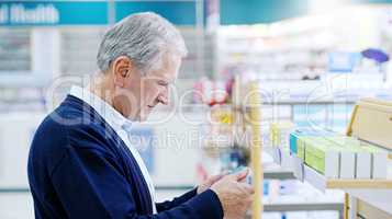 Its never too late to choose living a healthier life. Close up shot of a senior citizen deciding on which medicine to purchase at a pharmacy.