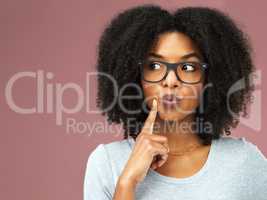 I better jump on that idea. Studio shot of an attractive young woman looking thoughtful against a pink background.