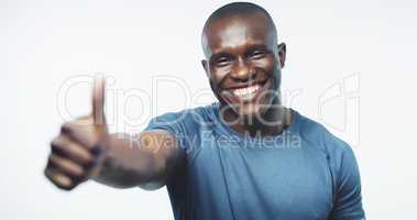 Cheers buddy, travel home safe. Studio shot of a handsome young man posing with his thumb up against a grey background.