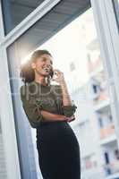 Keeping you happy in your most stressful of days. a young businesswoman making a phone call in her office.