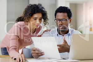 Were sorting out our finances today. a young couple doing some financial planning together at home.