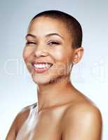 You are not defined by your hair. Studio shot of a beautiful young woman smiling against a grey background.