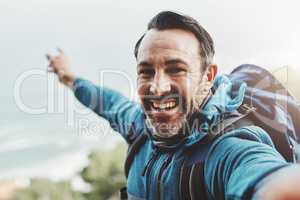 Come join me in exploring new grounds. Portrait of a middle aged man taking a selfie in the mountains.