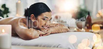 Pure relaxation. a relaxed an cheerful young woman getting a massage indoors at a spa.