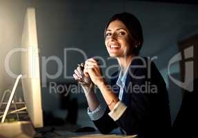Im investing it all in my career. Portrait of a young businesswoman working in an office at night.