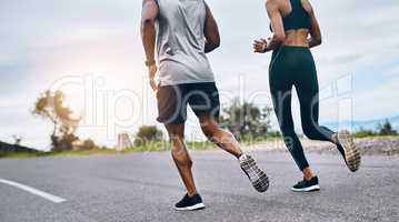 You dont need any equipment to get fit. Closeup shot of a sporty couple exercising together outdoors.