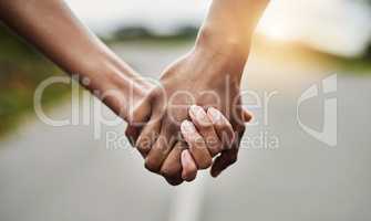 The journey of life is better when shared with a partner. Closeup shot of an unrecognizable couple holding hands together outdoors.