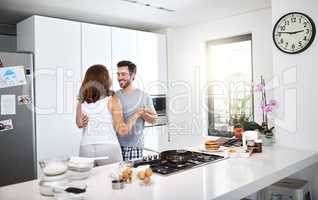 Dancing to the rhythm of the day. young couple dancing in the kitchen while preparing breakfast.