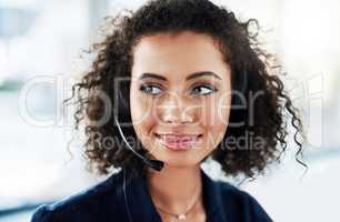 She has an idea that might help. an attractive young female call center agent looking thoughtful while working in her office.