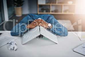 I refuse to face any more deadlines. a businessman lying down on a desk with a laptop over his head in an office.