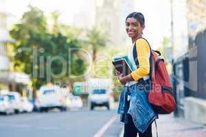 All set and ready to go to college. a young female student commuting to college in the city.