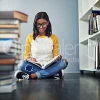 Hitting the books, studying for finals. a young female student studying at home.