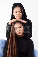 Natural hair will make you stop and stare. Studio shot of two beautiful young women posing against a grey background.