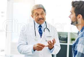 I want you to get plenty of exercise. a confident mature male doctor consulting with a patient inside of his office during the day.