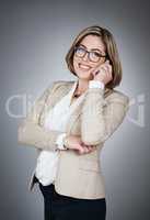 Connect with people who know what theyre talking about. Studio portrait of a young businesswoman using a mobile phone against a gray background.