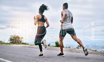 Keep chasing after those goals. Rearview shot of a sporty young couple exercising together outdoors.