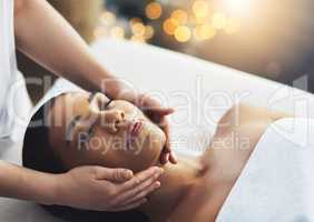 Total relaxation thanks to her massage therapist. an attractive young woman getting a massage at a spa.