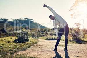 Fresh air and exercise. Full length shot of a handsome young man stretching before exercising outdoors.