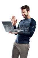 Hi Can you see me. Studio shot of a handsome young man using a laptop and waving against a white background.