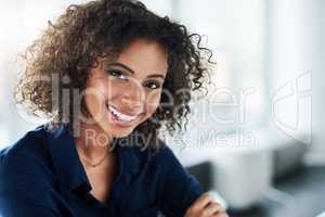 Be positive, and positivity will flow. Cropped portrait of an attractive young businesswoman working at her desk in the office.